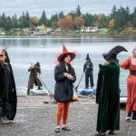 Witches in pointed hats and capes take to the cold waters of Jensen Point during the fifth annual Witches Paddle on Saturday. (Kent Phelan Photo)