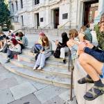 Eighth graders journal during a reflective moment on their learning trip to New Orleans. (Courtesy Photo)