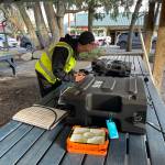 John Galus works at the Big Bird PCC to upload the latest channel listings onto a volunteers ham radio.