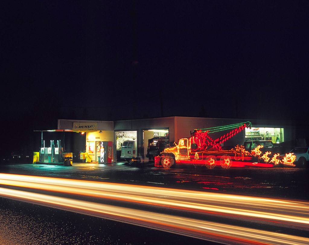 Engles service station with tow truck decorated in holiday lights at night in 2015. (Terry Donnelly Photo)