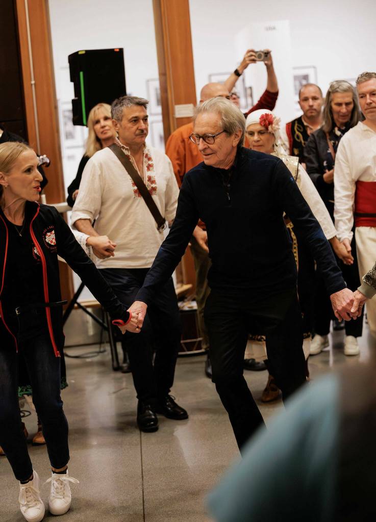 Martin Koenig (center) joined audience members in traditional dances after a night of music and dance that accompanied his Balkan Echoes exhibition at VCA. (Steve Rocketar Photo/www.rocketkar.com)