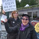Janie Starr (foreground) of Vashon-Maury Showing Up for Racial Justice (SURJ) was one of the organizers of the impromptu protest. At the event, she passed out leaflets providing information how to contact legislators and get involved in the work of Indivisible Vashon. (Jim Diers Photo)