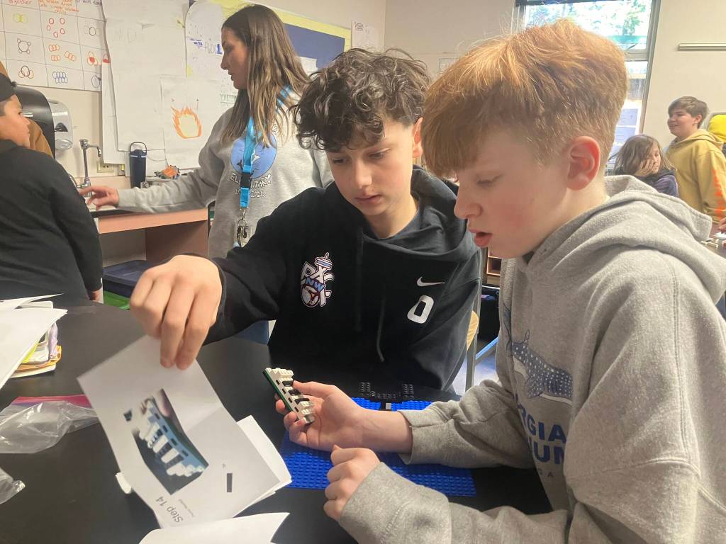 Henry, a seventh-grader (right) created a Lego project based on a ferry boat and Orca for his fifth-grade buddy, Micah. (Elizabeth Shepherd Photo)