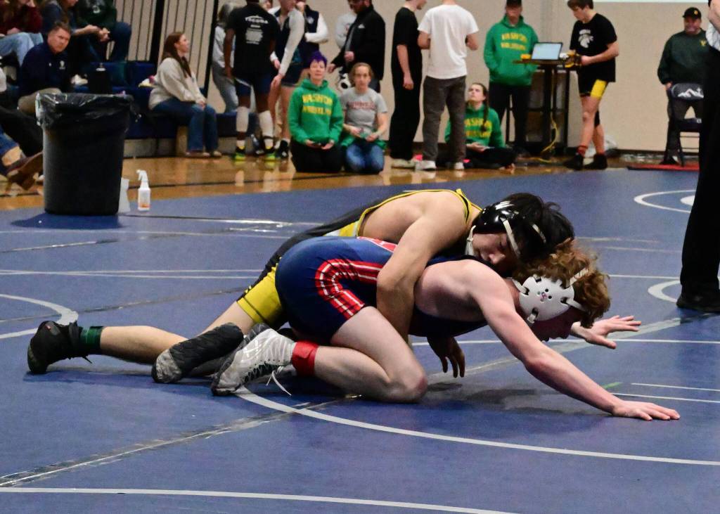 Senior Taevin Gilbert works to contain Life Christians King Stanley in the consolation semifinals. (Tony Puz Photo)