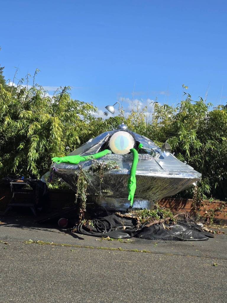 A prop alien climbs out of the UFO that was displayed at the Strawberry Festival on Vashon Island. (Matt Beursken Photo)