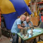 Rod Tharp, left, and Evan Simmons work at an industrial sewing machine. (Terry Donnelly Photo)
