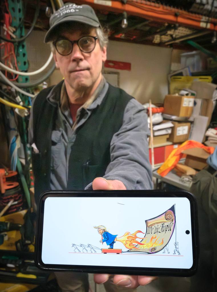 Bill Moyer holds an artists rendering of the new protest piece. (Terry Donnelly Photo)