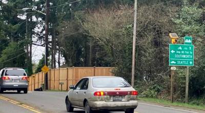 Cars prepare to turn left from Vashon Highway onto 103rd Avenue Southwest, the route to the Southworth ferry. (Eric Pryne Photo)