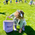 Two-year-old Hazel scoops up an egg at Ober Park on April 4 during the annual Eggstravaganza. Hazel and her family were visiting from San Diego, scouting a possible move to Vashon, when they stumbled onto the event.