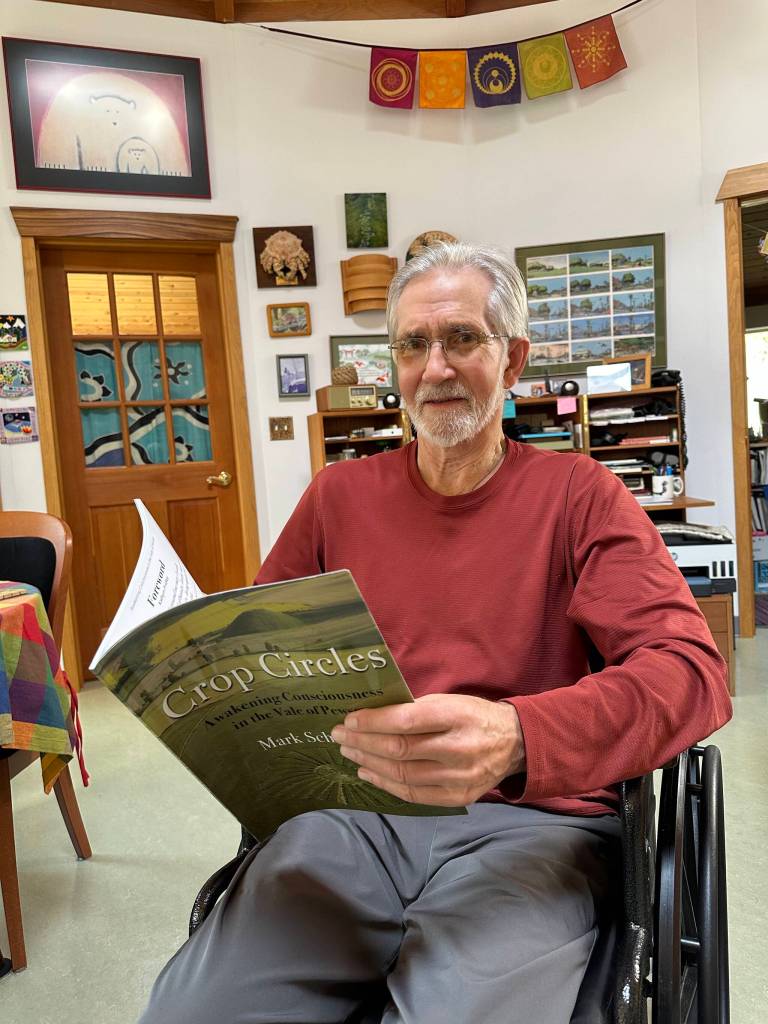 Courtesy Photo
Mark Schrader holds his book, Crop Circles ~ Awakening Consciousness in the Vale of Pewsey, a project completed in the final year of his life.