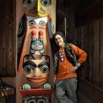 Courtesy Photo
Israel Shotridge stands next to the Eyak Totem, carved partially on Vashon and completed and raised in the clan house at the Alaska Native Heritage Center.