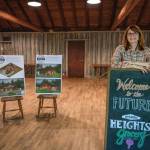 Terry Donnelly Photo
Jennifer Potter stands inside the historic Grange Hall, future home of Heights Grocery, with a rendering of the planned neighborhood market and coffee shop.
