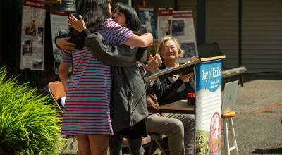 Kent Phelan Photos
Friends of Mukai Executive Director Jade Agua hugs artist Miya Sukune after Sukunes remarks at Saturdays ceremony.