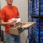 Terry Donnelly Photo
James Batey prepares shoes and gear in the stock room at Flostate Running before the stores June 5 opening.