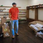 Terry Donnelly Photo
James Batey stands in the main room of Flostate Running, where shelves of running shoes line the new uptown shop.