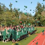 Paul Anderson Photo
Graduates toss their caps into the air Saturday at Vashon High School stadium.