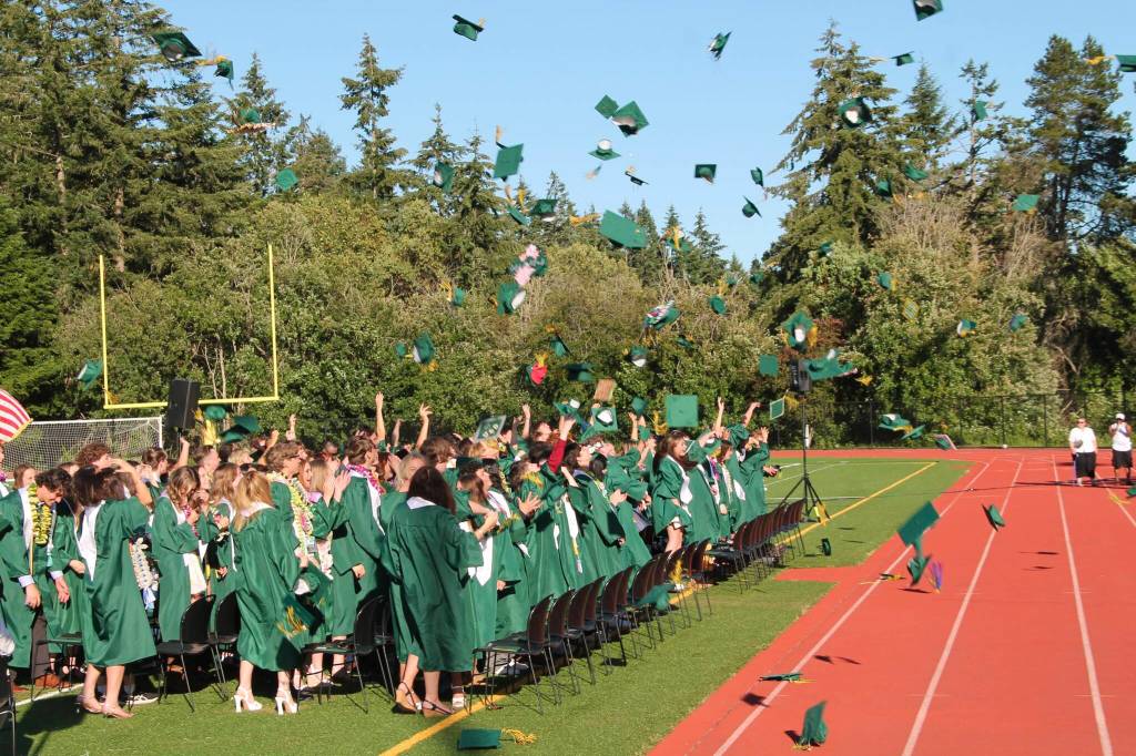 Paul Anderson Photo
Graduates toss their caps into the air Saturday at Vashon High School stadium.