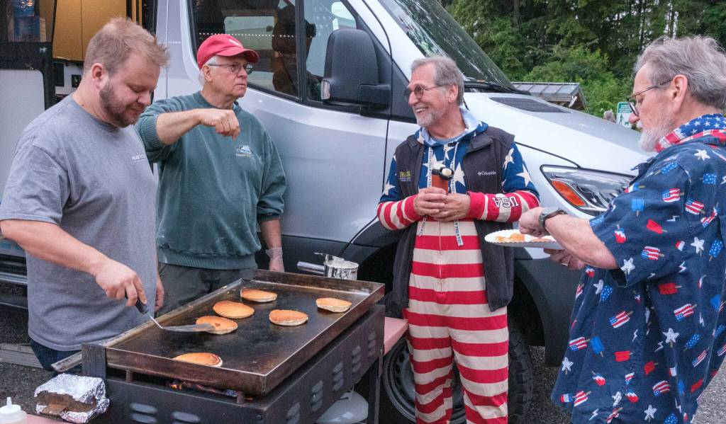 Terry Donnelly Photo
Islanders griddle pancakes at Jensen Point before Vashons annual Fourth of July hydroplane race.