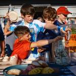 Kent Phelan Photo
Children gathered at a sidewalk table during First Friday festivities.