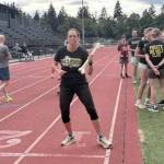 James Batey Photo
Megan Henderson carries a baton.
