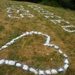 Kent Phelan Photo
Spray-painted rocks arranged on the grass honored Foss Miller during the inaugural Foss Miller Memorial All-Comers Track Meet at Vashon High School.