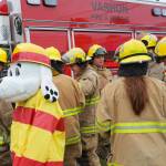 Jonathan Stein Photo
Vashon Island Fire & Rescue firefighters gather with Sparky the Fire Dog beside a fire engine during the Strawberry Festival Parade on Saturday.