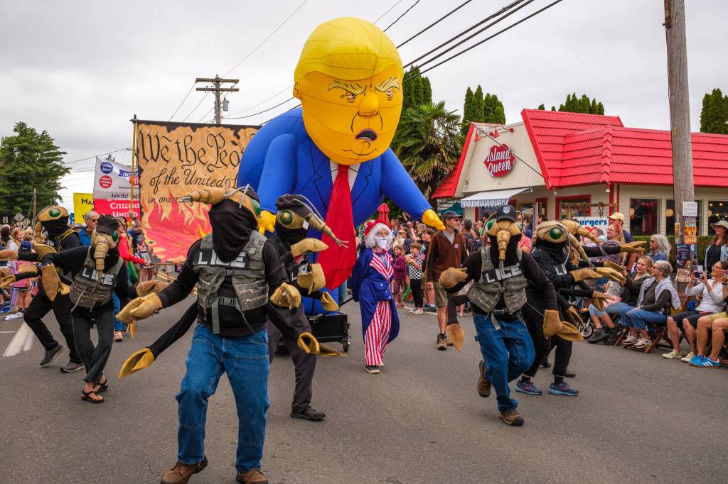 Kent Phelan Photo
Backbone Campaigns inflatable caricature of Donald Trump towers over marchers in the parade.