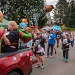 Kent Phelan Photo
Parade participants carry animal-shaped balloons and Adopt Me signs through a cloud of bubbles.