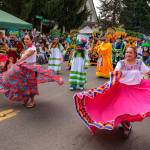 Kent Phelan Photo
Dancers in colorful traditional dress and masked performers bring a burst of color and movement to the parade.