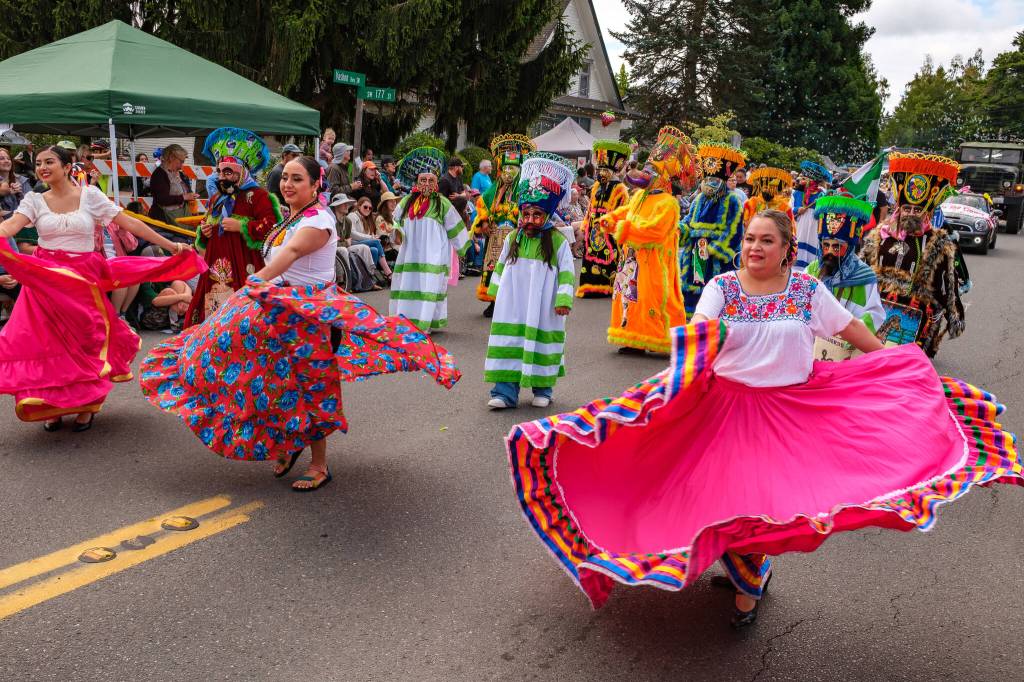 Kent Phelan Photo
Dancers in colorful traditional dress and masked performers bring a burst of color and movement to the parade.