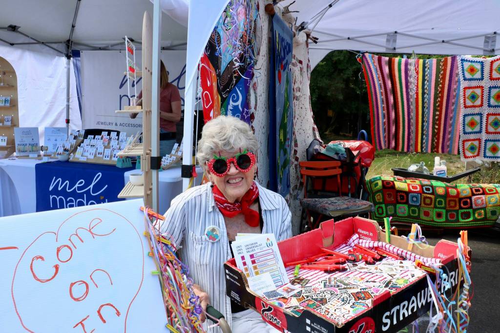 Scarlet Hansen Photo
Islander Jennifer Culp hands out prizes at the Vashon Island Unitarian Universalists booth.