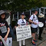 Protesters display signs opposing ICE during a July 25 vigil near Vashons four-way stop. (Kent Phelan Photo)