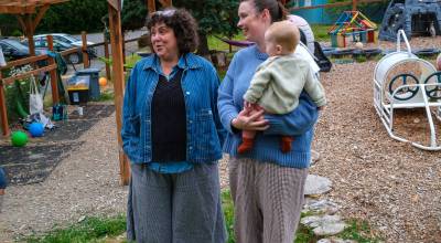 Parent educator Tami Brockway Joyce, left, stands on the co-op playground with class parent coordinator Fiona Lazare and her baby, Francis. (Kent Phelan Photo)