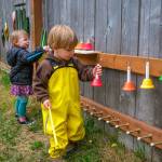 Calla and Elwyn play at the colorful music wall on the co-op playground. (Kent Phelan Photo)