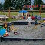 Elwyn and Ivo explore the sandbox on one of the co-ops two playgrounds. (Kent Phelan Photo)