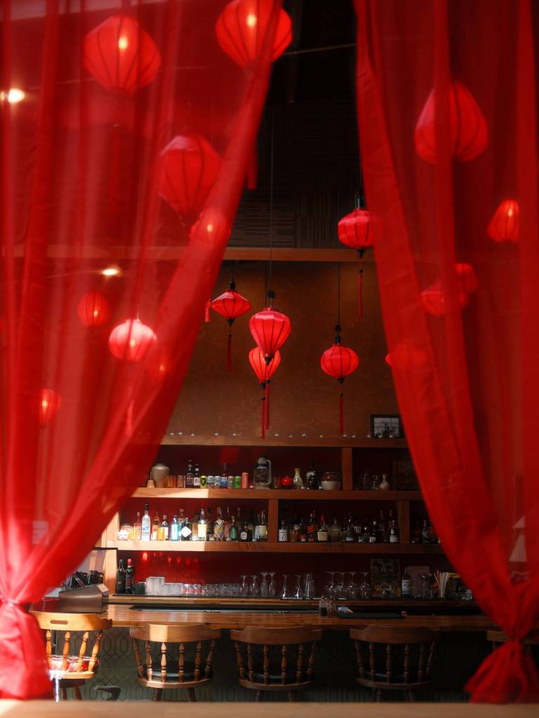 Red curtains frame the lantern-lit bar at Oh Vashon. (Mariel Torres Photo)