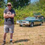 Brett Bacchus and his 1970 Oldsmobile Cutlass Supreme convertible, designated as the official Engels Show Car of 2026, in the field adjacent to Engels Repair and Towing. (Terry Donnelly Photo)